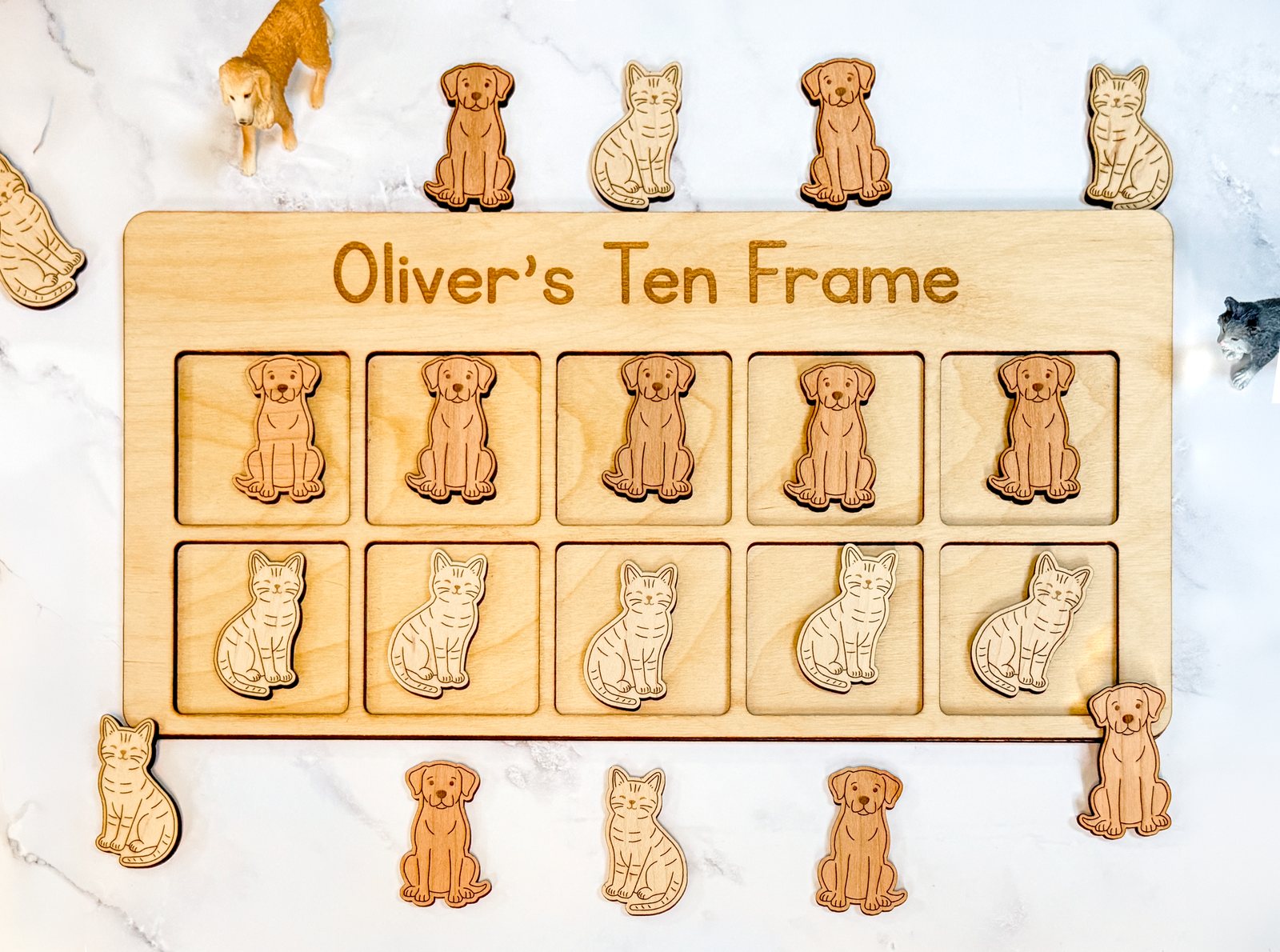 Pet-themed wooden ten frame with cat and dog counters for Montessori math