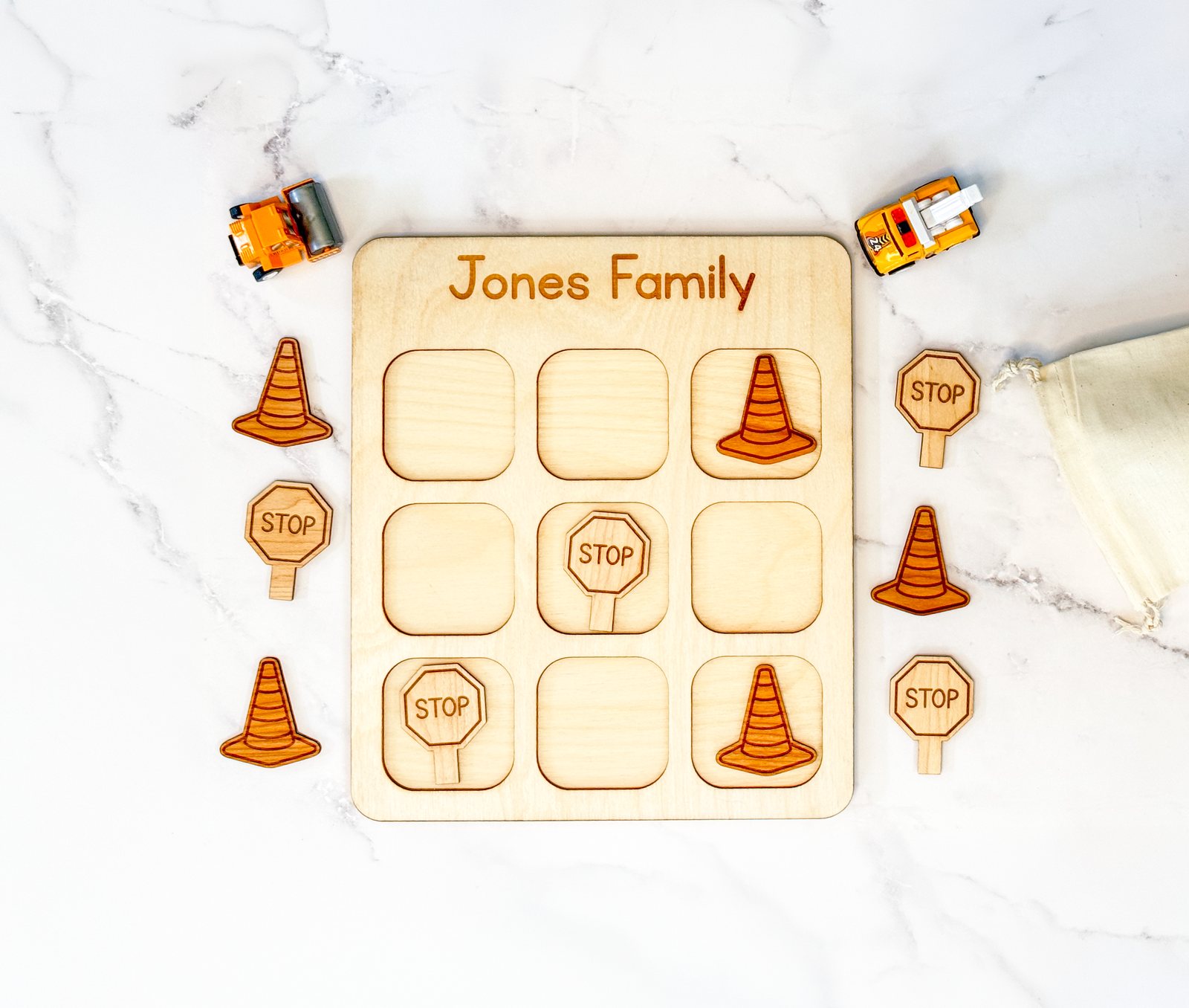 Construction-themed wooden travel tic tac toe board with vehicle pieces