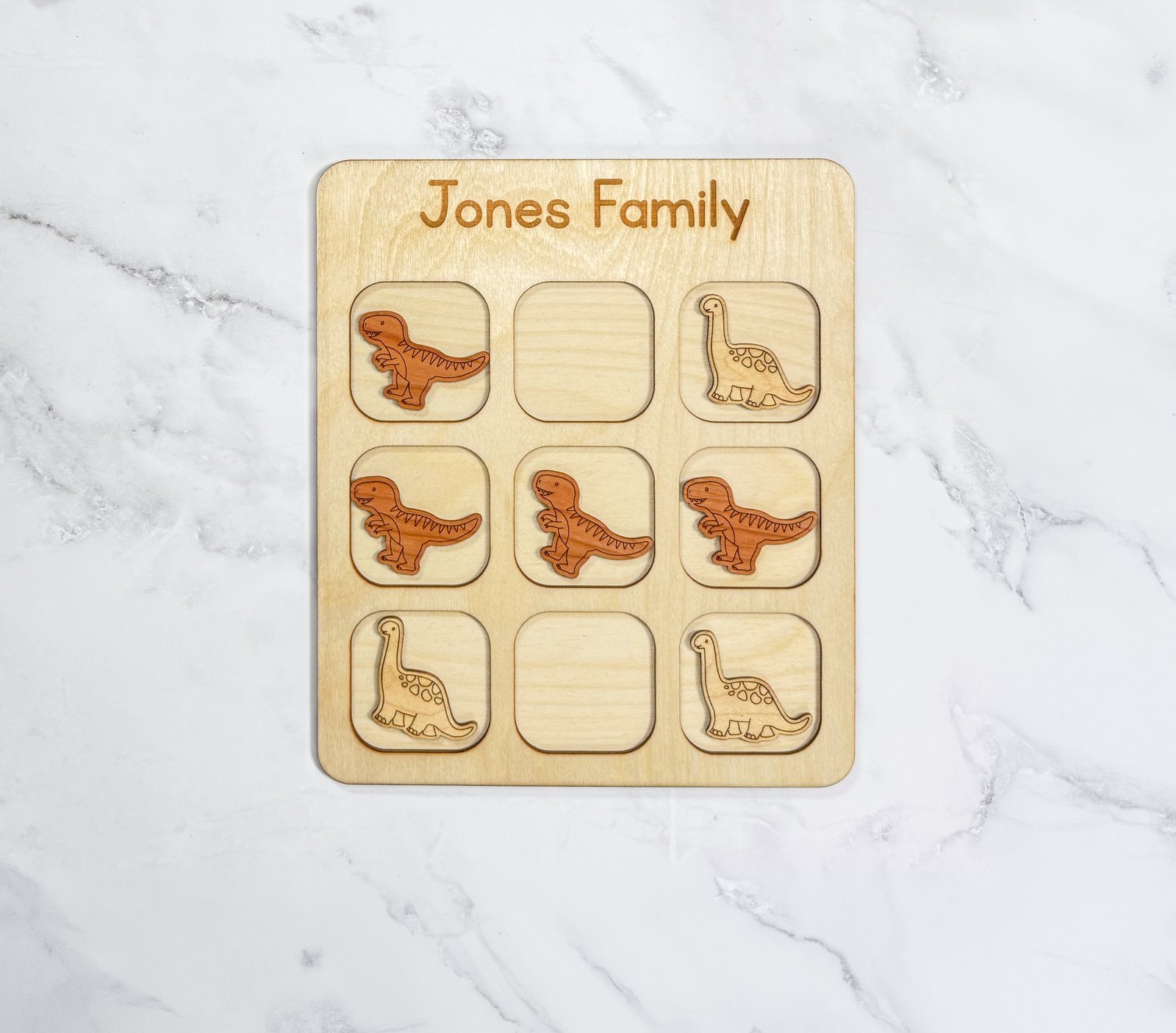Dinosaur-themed wooden travel tic tac toe board with dinosaur pieces
