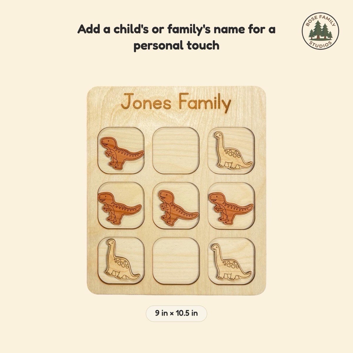Size reference graphic for the dinosaur tic tac toe board engraved 'Jones Family' at 9 x 10.5 in, showing laser-engraved Brontosaurus and T-rex pieces in neutral Baltic birch across the rounded three-by-three grid