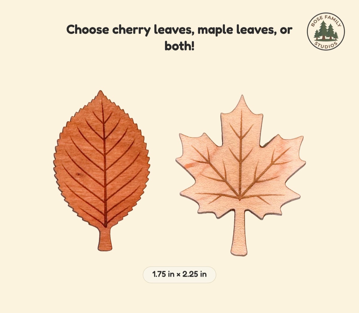 Size reference graphic with one cherry leaf counter in warm reddish wood beside a pale maple leaf counter, both laser-engraved with veins and labeled 1.75 in by 2.25 in, under the headline Choose cherry leaves, maple leaves, or both