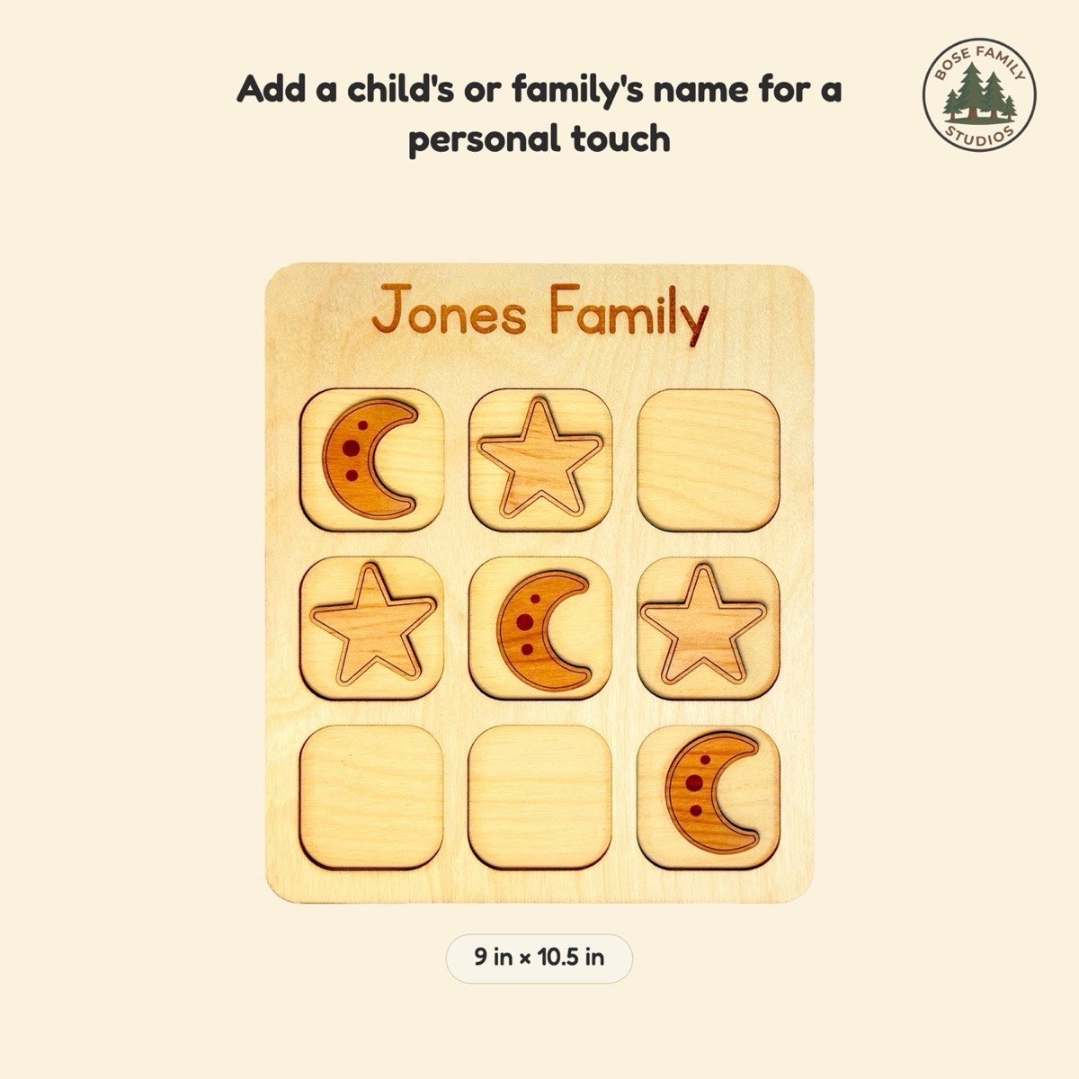 Size reference graphic for the space tic tac toe board engraved 'Jones Family' at 9 x 10.5 in, showing laser-engraved crescent moon and star pieces in neutral Baltic birch across the three-by-three grid